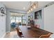 Bright dining area with a contemporary table, unique light fixture, and sliding doors to the patio at 6841 Roxbury Dr, Sarasota, FL 34231