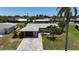 Well-maintained home with a paved driveway, mature landscaping, and a welcoming front entrance at 6841 Roxbury Dr, Sarasota, FL 34231