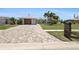 Charming single-story home featuring a well-manicured lawn, mature palm trees, and a paver driveway at 6841 Roxbury Dr, Sarasota, FL 34231
