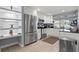 Modern kitchen with stainless steel appliances, white cabinetry, and sleek countertops at 6841 Roxbury Dr, Sarasota, FL 34231