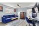 Comfortable living room with blue sofa, desk, and slider to porch at 6841 Roxbury Dr, Sarasota, FL 34231