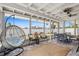 Relaxing screened porch with a hanging chair and furniture set at 6841 Roxbury Dr, Sarasota, FL 34231