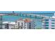 Aerial view of coastal buildings with red tile roofs, surrounded by the ocean and a bridge in the background at 688 Golden Gate Point # 701, Sarasota, FL 34236