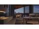Comfortable living room with a fireplace, patio access, and serene views of the marina and city skyline at 688 Golden Gate Point # 701, Sarasota, FL 34236