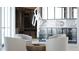 Modern living room featuring stylish seating, contemporary lighting, and a custom wine display with sleek countertops and storage at 688 Golden Gate Point # 701, Sarasota, FL 34236