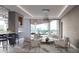 Open living area with large windows, city views, a bar, and contemporary furniture; spacious and well-lit at 688 Golden Gate Point # 701, Sarasota, FL 34236