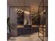 Contemporary wine cellar boasts a wood ceiling, multiple wine racks, ambient lighting, and display shelves at 688 Golden Gate Point # 701, Sarasota, FL 34236