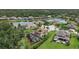 Aerial view of a home overlooking a lake, showcasing lush landscaping and a private screened-in pool at 6907 47Th E Ct, Ellenton, FL 34222