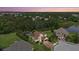 An aerial shot showing a beautifully landscaped property with a pool, lawn, and mature trees at 6907 47Th E Ct, Ellenton, FL 34222