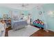 Turquoise bedroom featuring hardwood floors, bright lighting, a white shag rug, and decorations at 6907 47Th E Ct, Ellenton, FL 34222