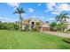 Beautiful two-story home with well-manicured lawn, mature trees, and a brick driveway at 6907 47Th E Ct, Ellenton, FL 34222