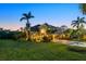 Beautiful two-story home with a lush lawn and meticulous landscaping at dusk at 6907 47Th E Ct, Ellenton, FL 34222