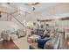 Open-concept living room features soaring ceilings, a staircase, and is open to the eat-in kitchen with a center island at 6907 47Th E Ct, Ellenton, FL 34222