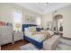 Serene primary bedroom with a tray ceiling, calming decor, and bright windows at 6907 47Th E Ct, Ellenton, FL 34222