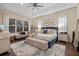 Well-lit primary bedroom with a tray ceiling, a large window, and wood flooring at 6907 47Th E Ct, Ellenton, FL 34222