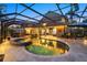 The screened-in pool with spa is surrounded by pavers and outdoor seating at 6907 47Th E Ct, Ellenton, FL 34222