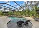 A screened-in backyard pool features a spa and in-pool seating for relaxing and enjoying the outdoors at 6907 47Th E Ct, Ellenton, FL 34222