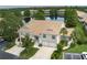 Stunning aerial view of a home with a tile roof overlooking a serene lake at 7035 Scrub Jay Way # 202, Bradenton, FL 34203