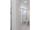 Modern bathroom with glass shower, white tiled walls, and tiled floor at 7035 Scrub Jay Way # 202, Bradenton, FL 34203