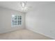 Bright bedroom with neutral carpet and a window with plantation shutters at 7035 Scrub Jay Way # 202, Bradenton, FL 34203