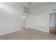 Bright bedroom featuring neutral carpet, ceiling fan, and ensuite bathroom entrance at 7035 Scrub Jay Way # 202, Bradenton, FL 34203