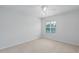 Bright bedroom with neutral carpet and a window with plantation shutters at 7035 Scrub Jay Way # 202, Bradenton, FL 34203