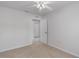 Bright bedroom features neutral walls, ceiling fan, and carpeted floors at 7035 Scrub Jay Way # 202, Bradenton, FL 34203