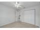 Bedroom features neutral carpet, ceiling fan and double door closet at 7035 Scrub Jay Way # 202, Bradenton, FL 34203