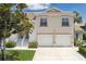Charming home exterior featuring a two-car garage and well-manicured landscaping at 7035 Scrub Jay Way # 202, Bradenton, FL 34203