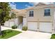 Charming townhome exterior with attached garages and manicured landscaping under a sunny sky at 7035 Scrub Jay Way # 202, Bradenton, FL 34203
