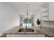 Open kitchen with granite countertops and stainless steel sink overlooking the living area and outdoor view at 7035 Scrub Jay Way # 202, Bradenton, FL 34203