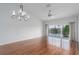 Spacious living room featuring hardwood floors, modern chandelier, and water views from the lanai at 7035 Scrub Jay Way # 202, Bradenton, FL 34203