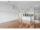 Bright living room featuring hardwood floors, chandelier, and an open layout leading to the kitchen at 7035 Scrub Jay Way # 202, Bradenton, FL 34203