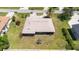 Aerial view of a well-maintained single-story home, showcasing the backyard and surrounding landscape at 710 Beverly Rd, Venice, FL 34293