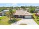 Aerial view of a single story home featuring mature palm trees and stone accents at 710 Beverly Rd, Venice, FL 34293