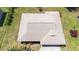 An overhead shot of a well-maintained roof surrounded by lush landscaping and healthy green lawns at 710 Beverly Rd, Venice, FL 34293