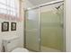 Bathroom featuring sliding glass shower doors and mint green tile at 710 Beverly Rd, Venice, FL 34293