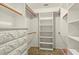 Walk-in closet with custom shelving, dresser, and rod system at 710 Beverly Rd, Venice, FL 34293