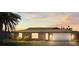 Charming single-story home with a well-manicured lawn and a beautiful sunset backdrop at 710 Beverly Rd, Venice, FL 34293