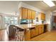 A kitchen featuring wood cabinets, countertop seating, and open access to the living room at 710 Beverly Rd, Venice, FL 34293