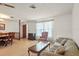 Open-concept living area featuring wood-look floors, large windows and vintage sofa at 710 Beverly Rd, Venice, FL 34293