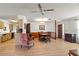 Spacious living room with wood floors, kitchen pass-through and dining area at 710 Beverly Rd, Venice, FL 34293
