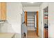 Walk-in pantry area with wooden shelving, and folding wooden doors at 710 Beverly Rd, Venice, FL 34293