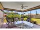 Comfortable screened patio with a ceiling fan and outdoor seating offering views of the yard at 710 Beverly Rd, Venice, FL 34293