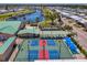 Aerial view showcasing tennis courts, the harbor, and waterfront homes in a vibrant community setting at 714 N Waterway Dr, Venice, FL 34285