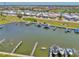 Wide aerial view showing the marina with dockage, boats, and surrounding community at 714 N Waterway Dr, Venice, FL 34285