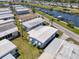 An aerial shot showing single story homes with aluminum roofs and nearby access to the community marina at 714 N Waterway Dr, Venice, FL 34285