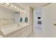 Bathroom featuring a large vanity and a view into the carpeted bedroom at 714 N Waterway Dr, Venice, FL 34285