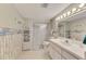 This bathroom has a shower, sink and toilet with nice wallpaper and decorations at 714 N Waterway Dr, Venice, FL 34285