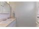 A clean bathroom with bright lighting and tasteful wallpaper at 714 N Waterway Dr, Venice, FL 34285